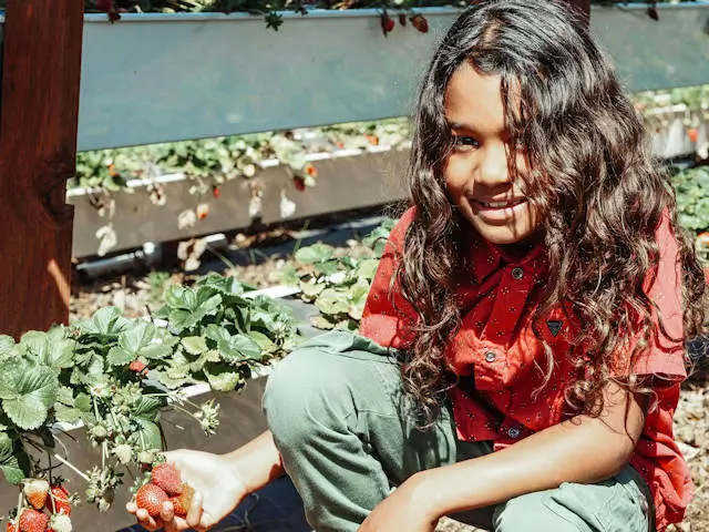 Child with fresh strawberries