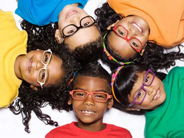 Smiling kids with their heads together